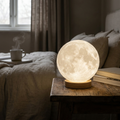Selene 3D moon lamp glowing on a bedside table