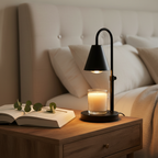 Lumio candle warmer lamp glowing on a cozy bedroom nightstand