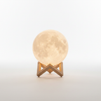 Selene 3D moon lamp on its wooden stand, white background