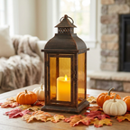 Harvest Glow Fall Candle Lantern with flickering LED candle among autumn leaves