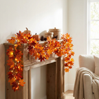 Amber Maple Lighted Fall Garland glowing along a fireplace mantel