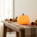Jack Glow Pumpkin Night Light glowing on an autumn console table