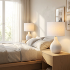Cova Ceramic Table Lamp Set of two white lamps glowing on bedside tables