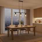 Orbit pendant set glowing over a dining table at dusk
