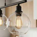Close-up of a clear glass globe shade and warm bulb