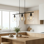 Orbit pendant set above a kitchen island in a bright modern home