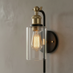 Close-up of the black frame, gold accent and clear glass shade