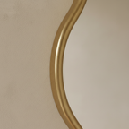 Close-up of Asha mirror brushed gold organic frame edge