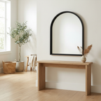 Arche Black Wall Mirror mounted above an entryway console