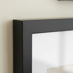 Close-up macro detail of a black wooden picture frame corner and glass front