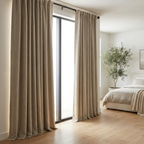 Lumiere Blackout Linen Curtains hung floor to ceiling in a modern bedroom